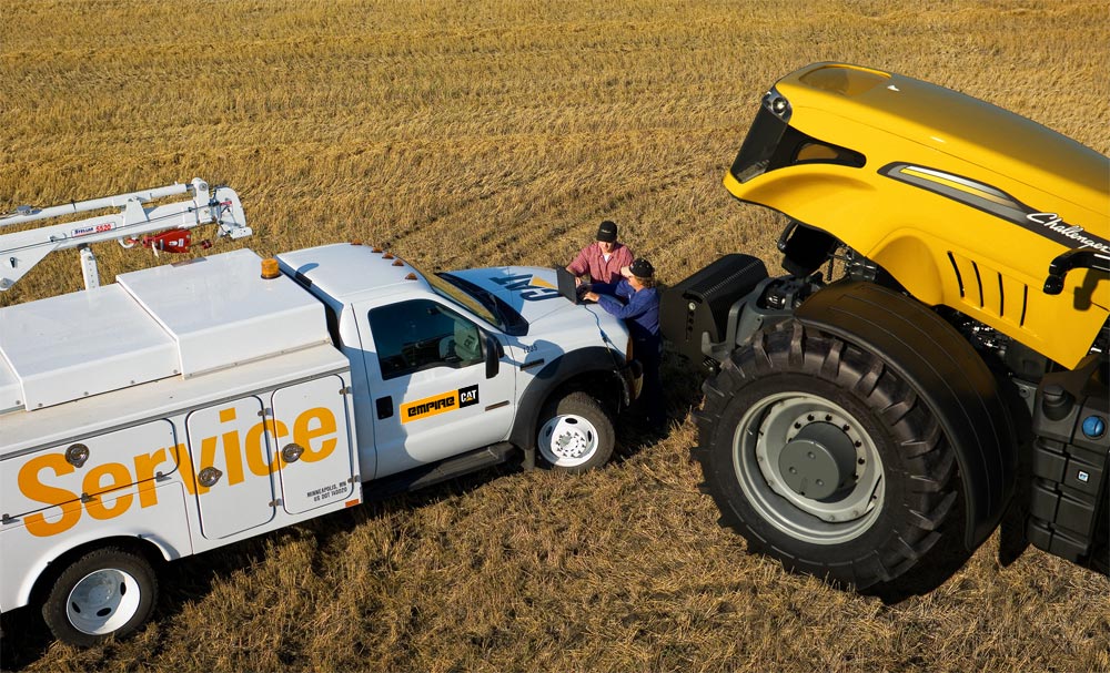 field technician servicing a challenger tractor 