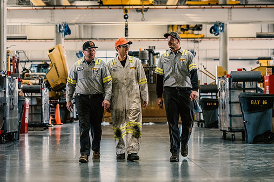 technicians walking together in the shop