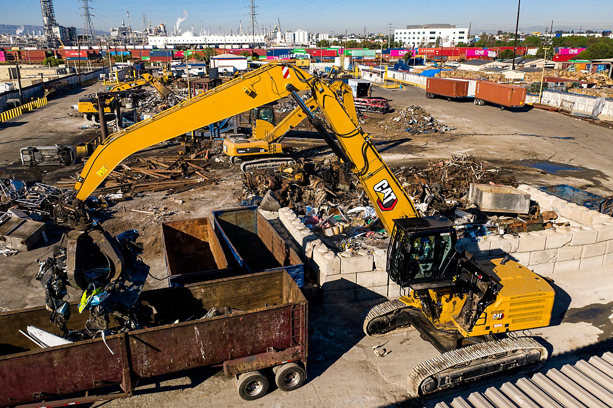 material handlers lifting metal scrap from container