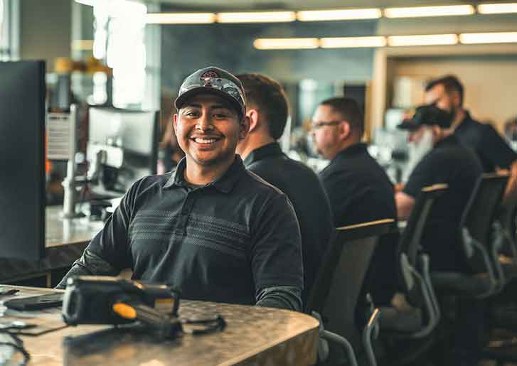 men sitting at the parts counter smiling