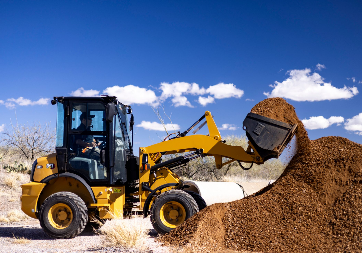 compact wheel loader lift dirt from pile with bucket