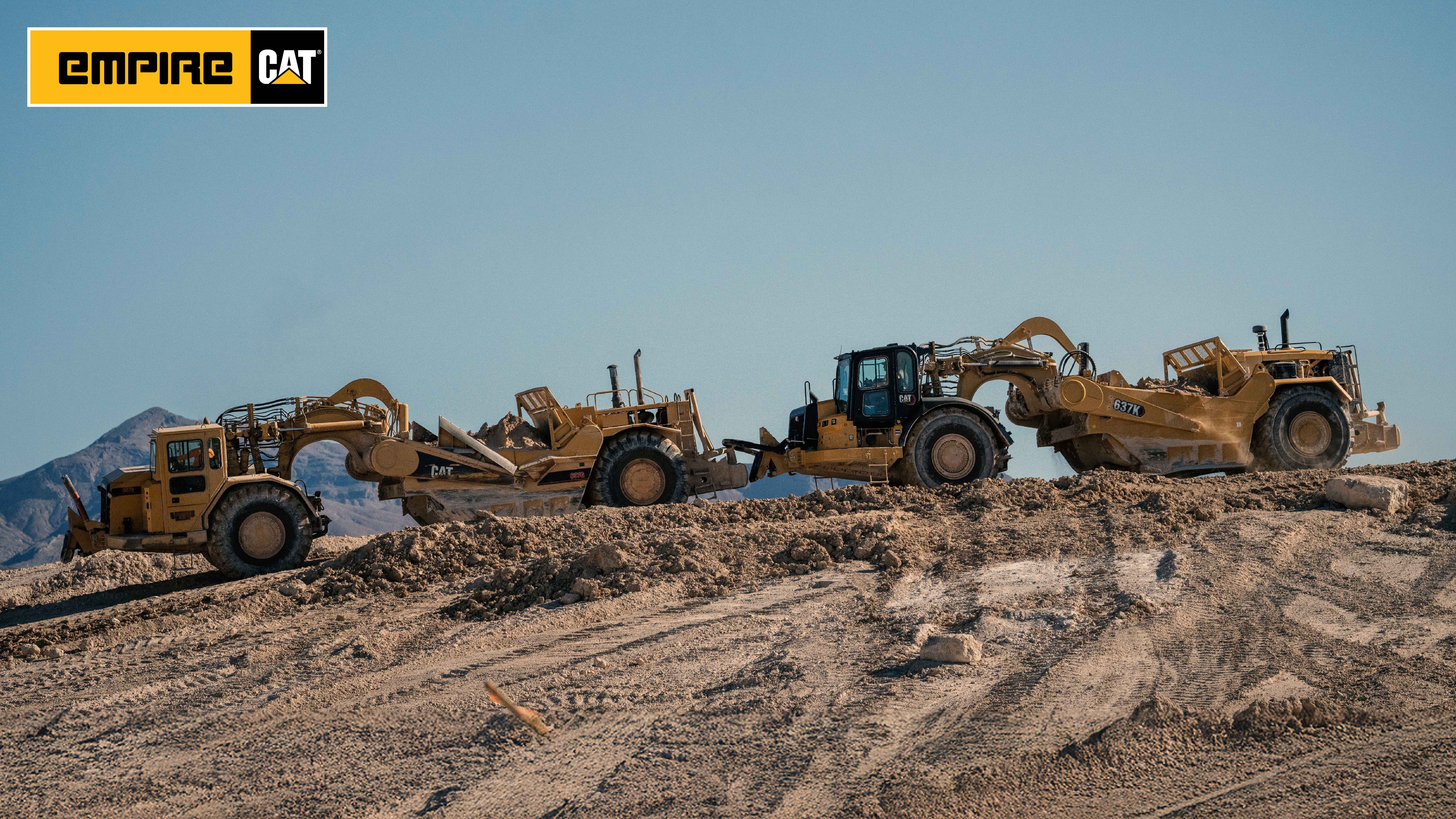 tow motor graders on a hill