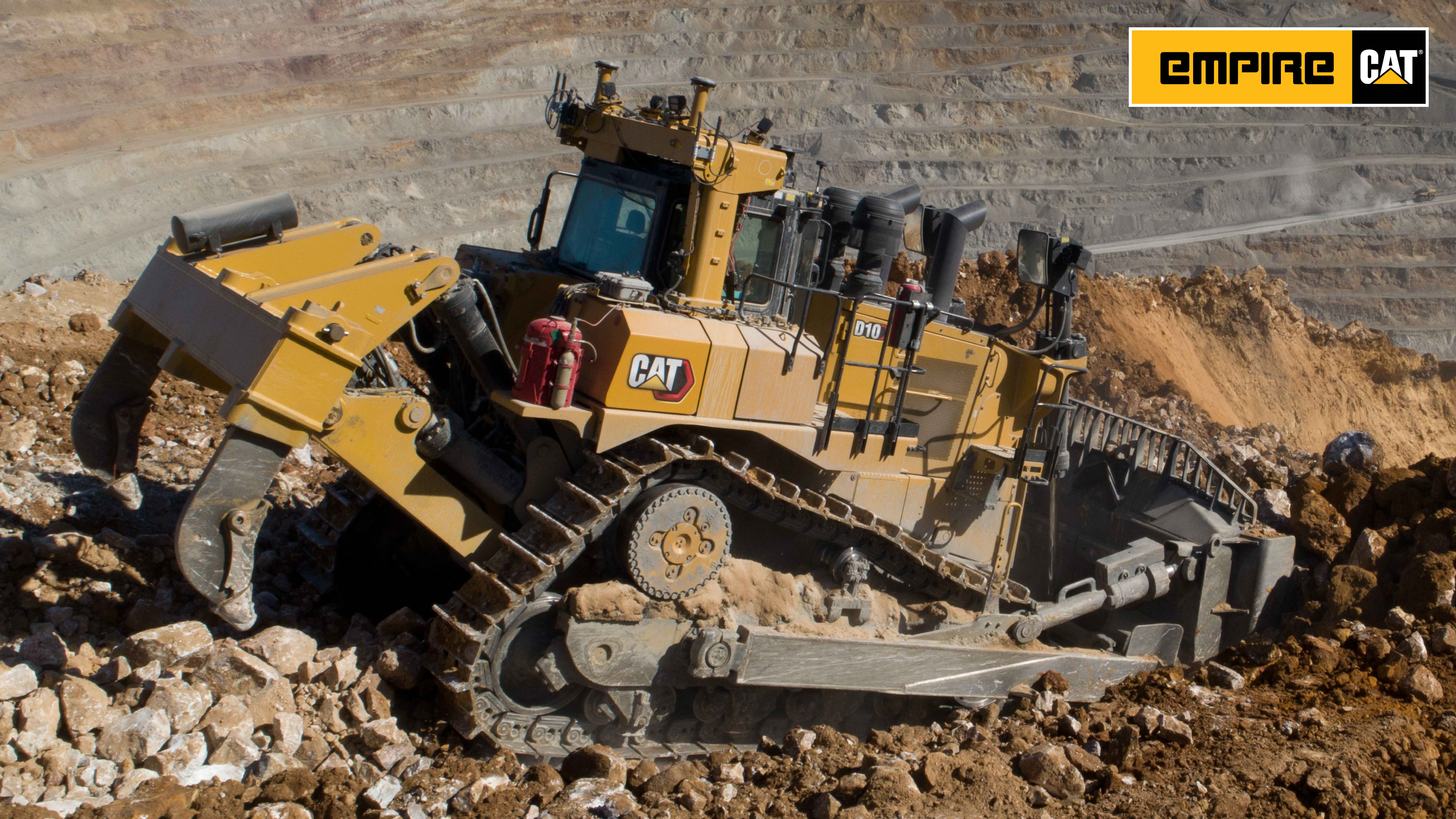 Large track loader moving over ruble