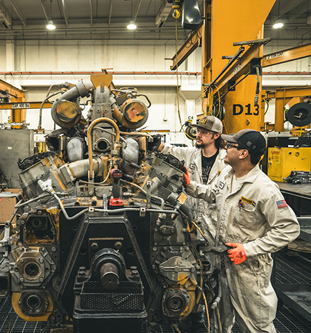 shop technicians standing in the shop talking